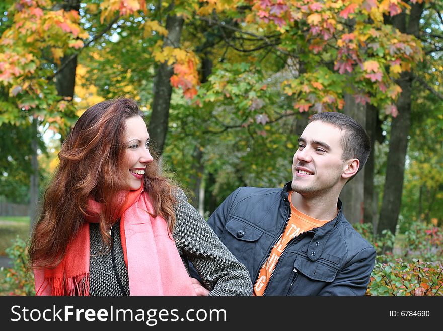 Funny couple having fun in autumn park