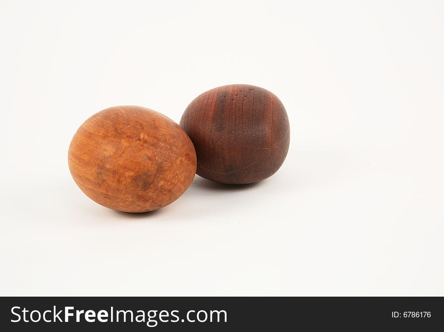 Two wooden eggs isolated on white background