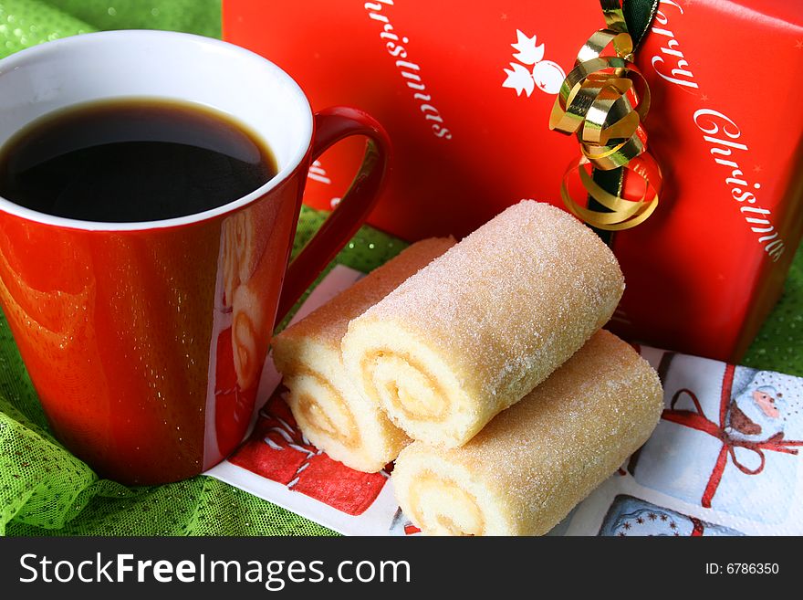 Christmas morning coffee with a gift and swiss roll. Christmas morning coffee with a gift and swiss roll