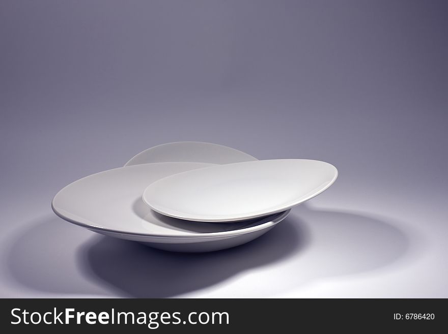 White plates and studio lighting shadows