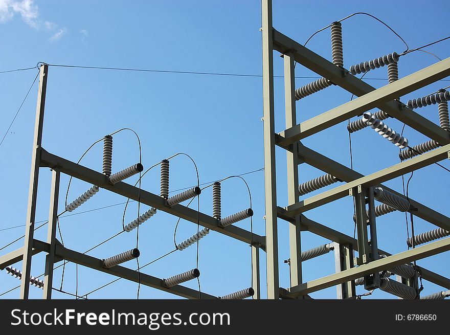 Electricity transmission grid against blue sky. Electricity transmission grid against blue sky