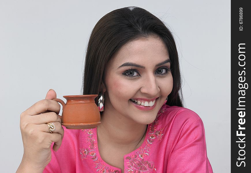 Asian woman drinking tea in a earthen cup