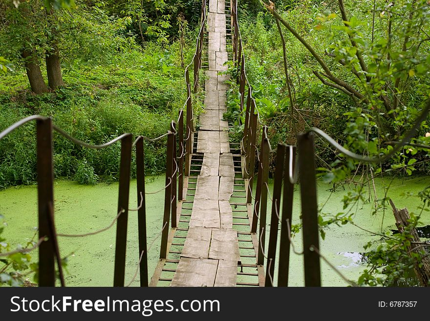 Old bridge hanging over the small river. Old bridge hanging over the small river