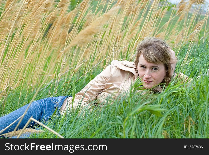 The girl lays in canes and looks in the cam. The girl lays in canes and looks in the cam