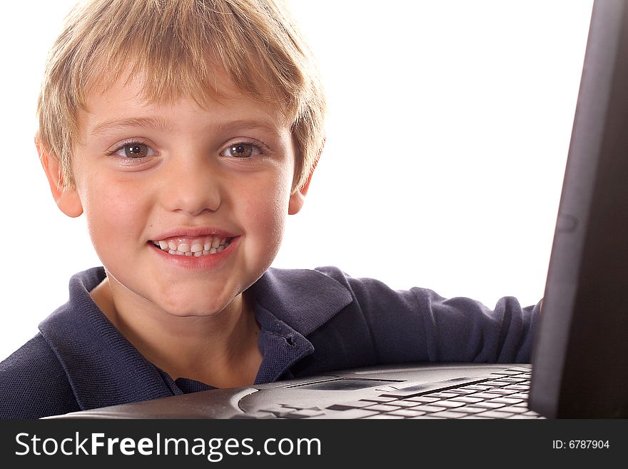 Shot of a happy little boy with laptop computer