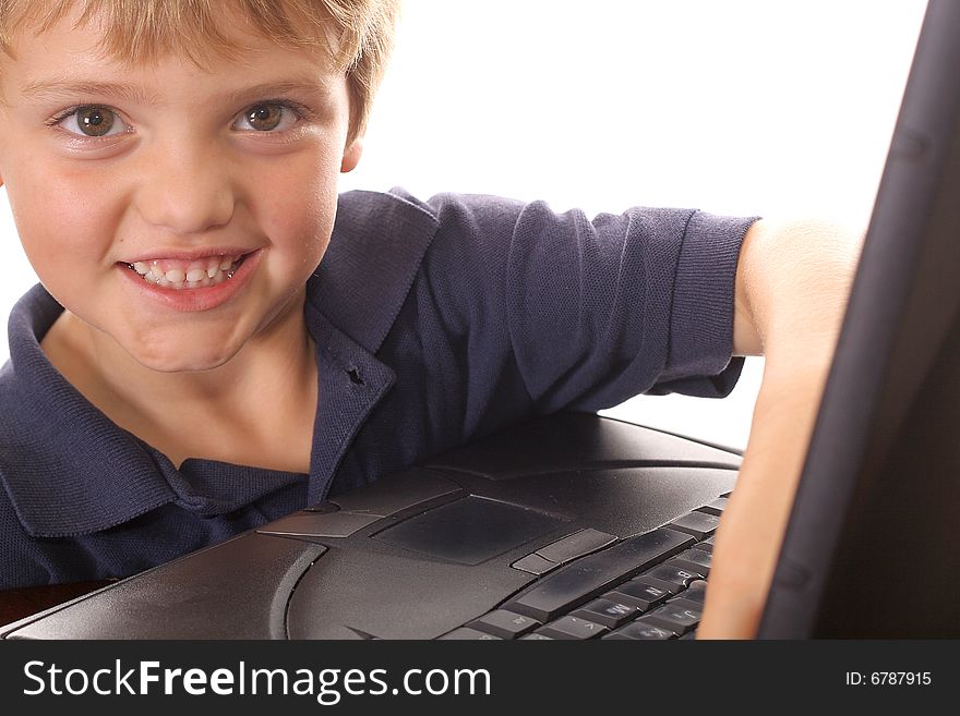 Happy little boy checking emails on computer isolated on white