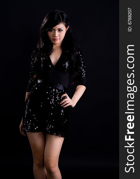 Beautiful asian girl in a glittering black cocktail dress. Beautiful asian girl in a glittering black cocktail dress