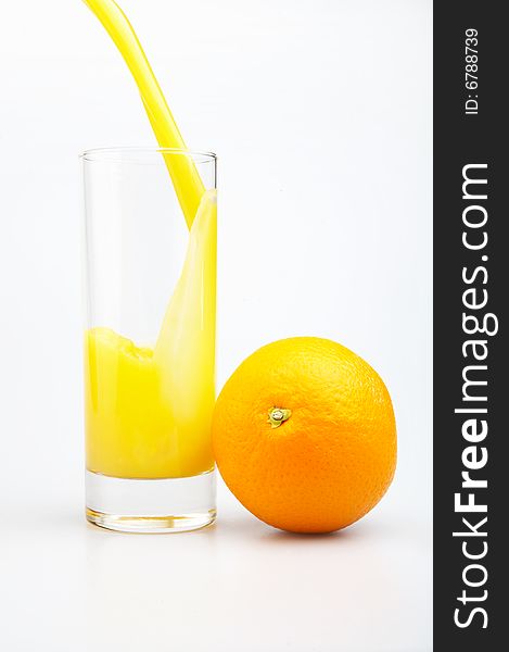 Glass of juice and orange on a white background. Glass of juice and orange on a white background