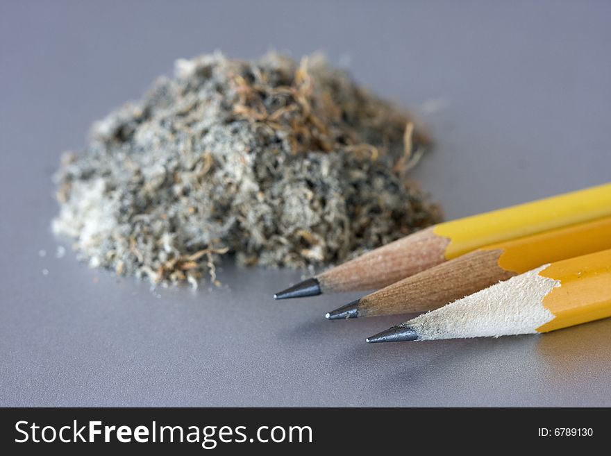 Three pencils with shavings in the background