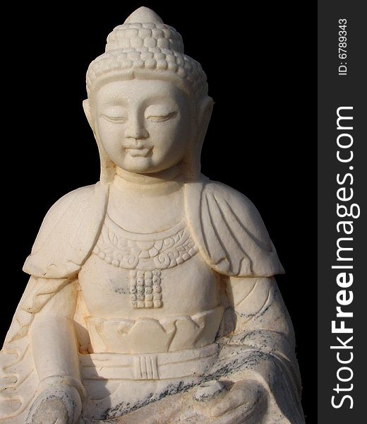 Buddhist statue in white marble on black background