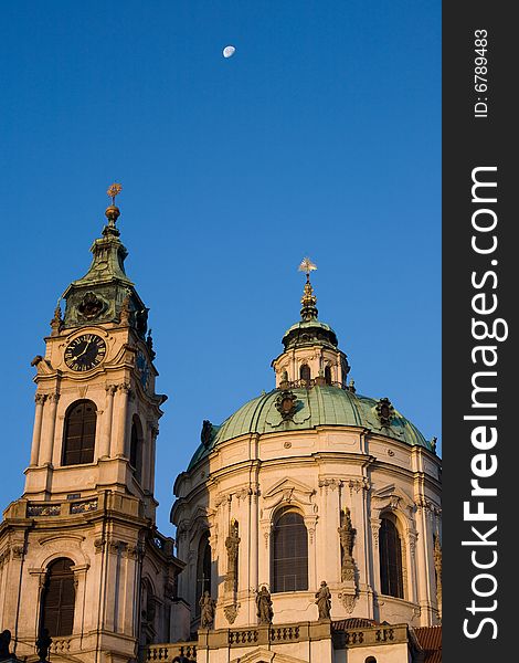 Baroque style St. Nicholas church in Prague with half moon. Baroque style St. Nicholas church in Prague with half moon.