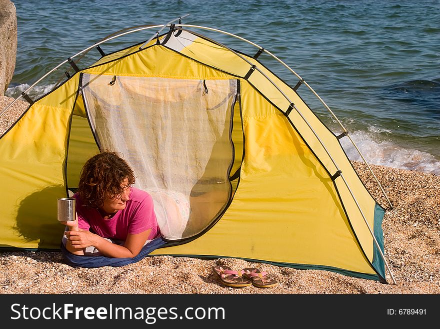 Girl with mug of coffee at seaside