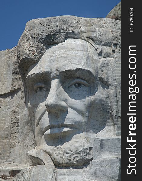 The large head of president lincoln carved in granite. The large head of president lincoln carved in granite