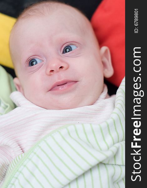 A little cute newborn baby  lying on bed with her eyes open