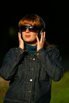 Girl With Headphones In Glasses Stock Photo