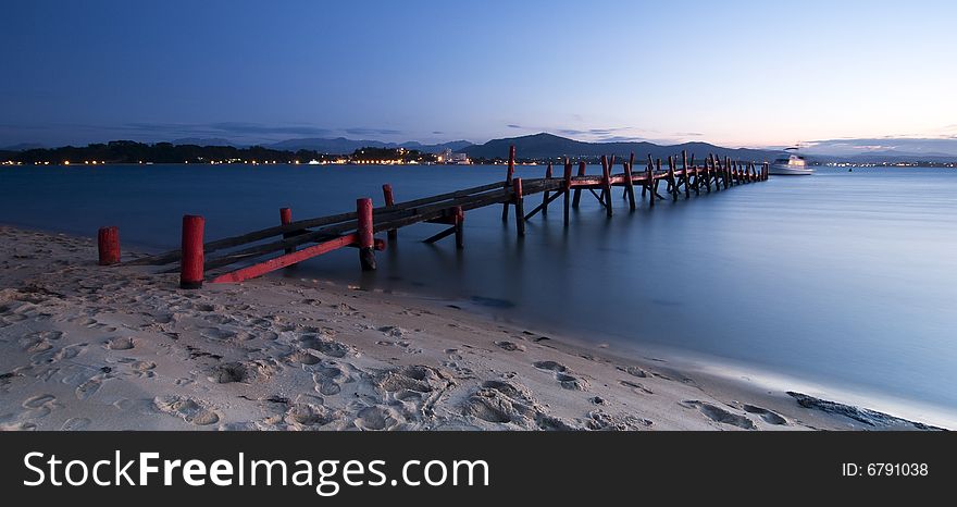 An old red dock at the beach