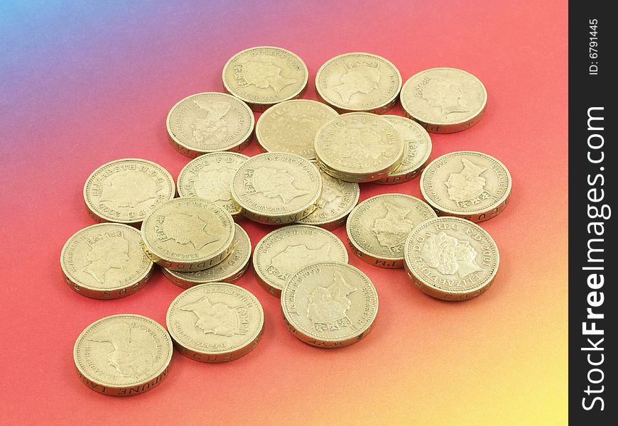 Pounds coins on a colorful (rainbow-like) background