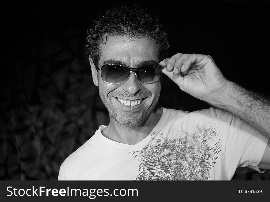 man poses with sunglasses