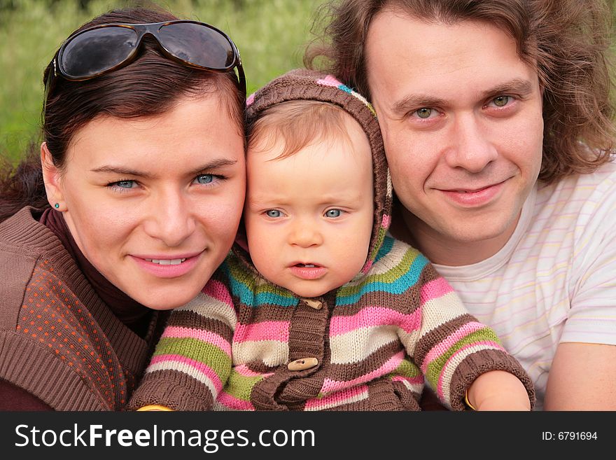 Parents with child on nature, summer