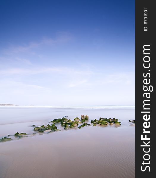 A group of green stones at the beach