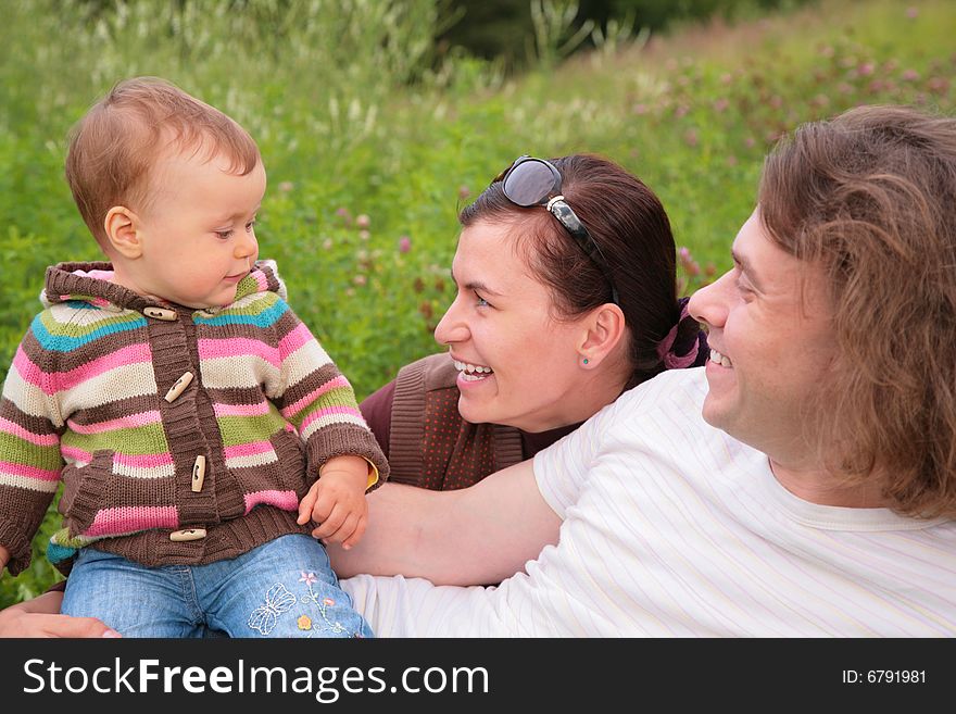 Parents with baby on nature, summer