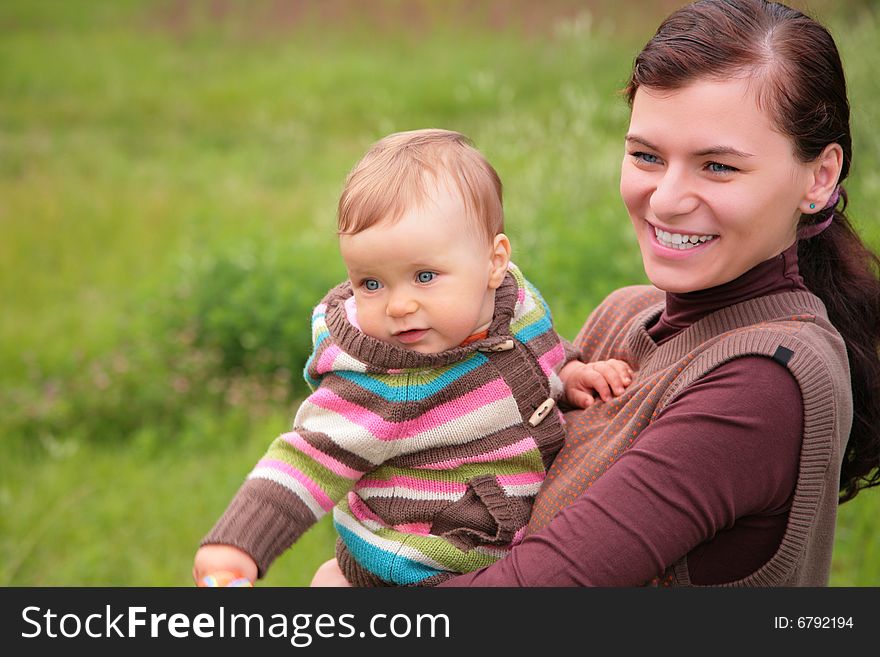 Mother with baby on nature, summer