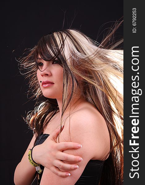 Young woman in studio with moving hair