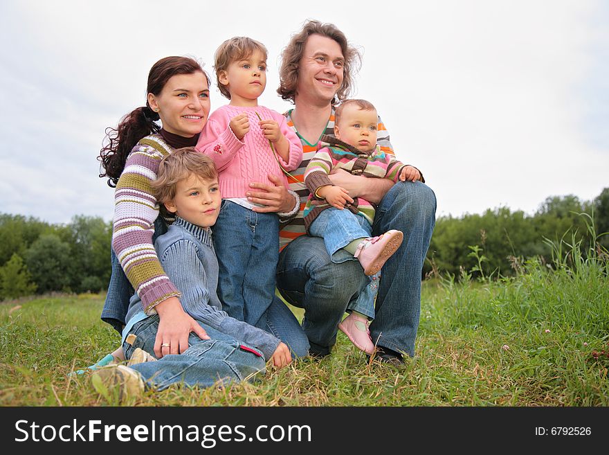 Family of five portrait on nature