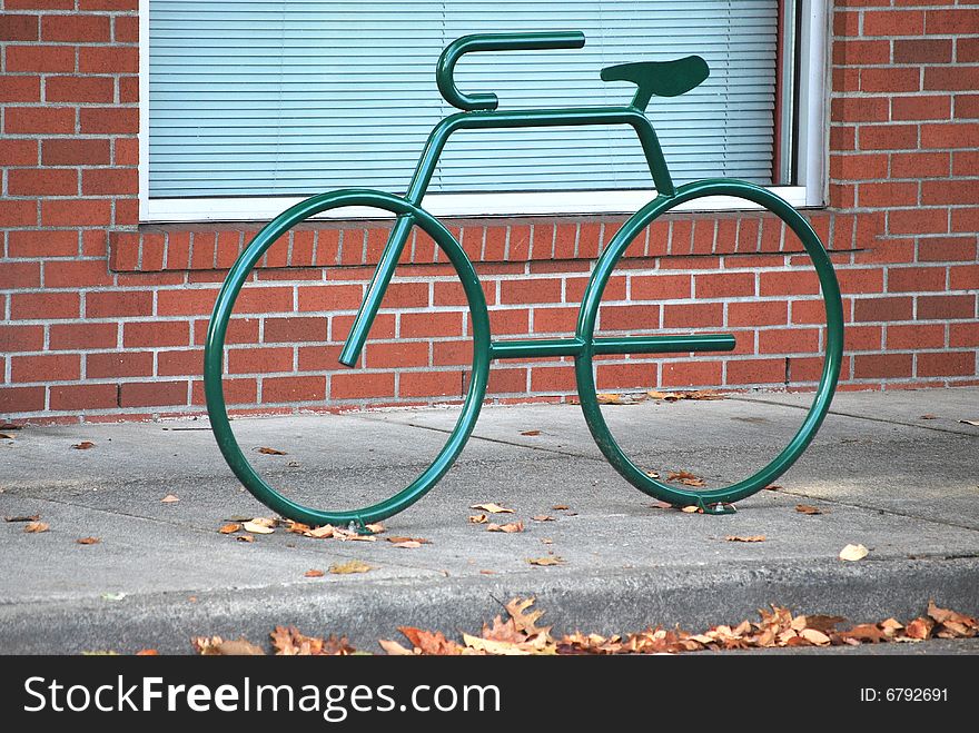 Green bike rack on a public street.