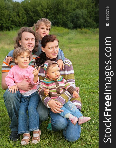 Family of five portrait on grass