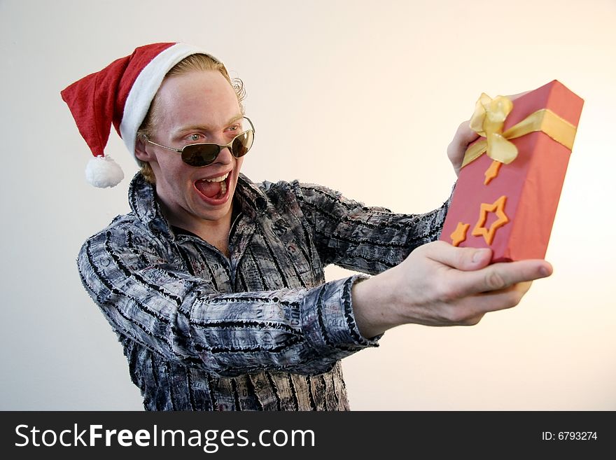 A showoff wearing an xmas hat presenting a gift. A showoff wearing an xmas hat presenting a gift.