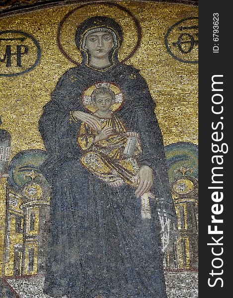 The Comnenus mosaics, equally located on the eastern wall of the southern gallery, date from 1122. The Virgin Mary is standing in the middle, depicted, as usual in Byzantine art, in a dark blue gown. She holds the Child Christ on her lap (wikipedia). The Comnenus mosaics, equally located on the eastern wall of the southern gallery, date from 1122. The Virgin Mary is standing in the middle, depicted, as usual in Byzantine art, in a dark blue gown. She holds the Child Christ on her lap (wikipedia).