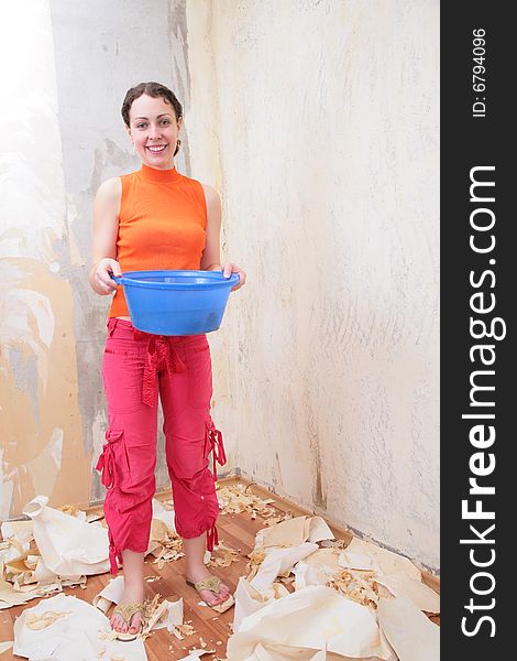 Girl with basin of water makes room renovations. Girl with basin of water makes room renovations