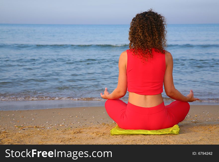 Yoga girl on beach from back, summer