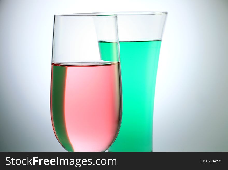 Glass with Pink and Green Juice on White Background