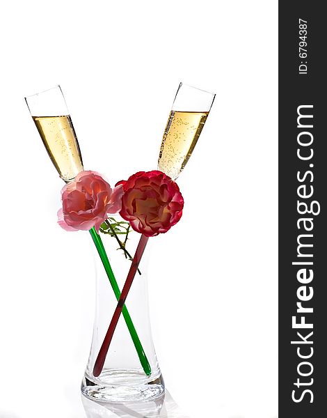 Two flutes of champagne and rose on white background