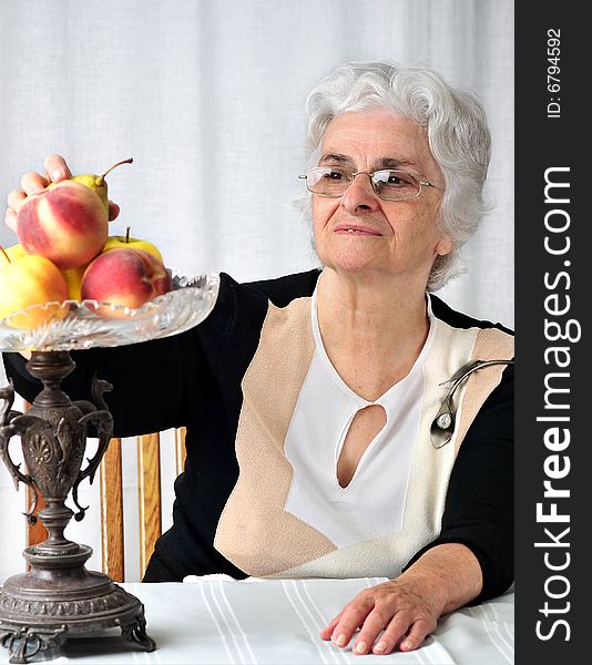 Senior lady looking at the fruits