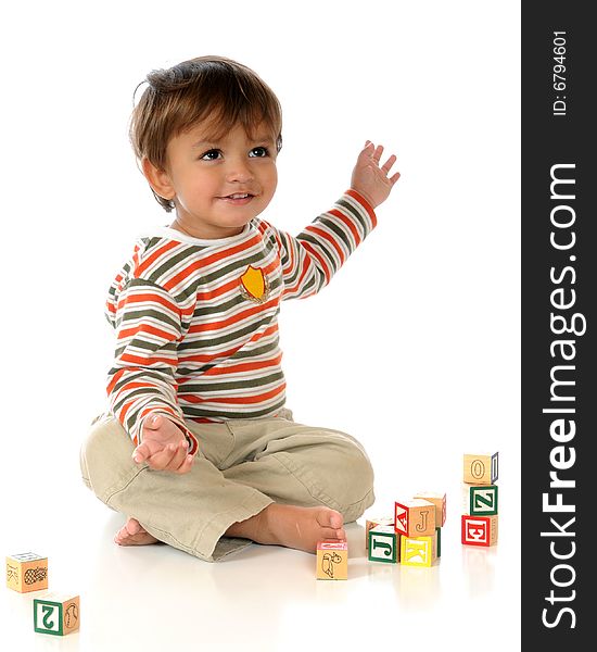 Baby boy delighted with his stacked alphabet blocks. Isolated on white. Baby boy delighted with his stacked alphabet blocks. Isolated on white.