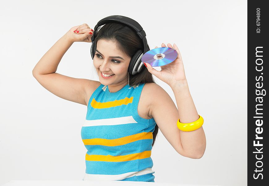 Asian woman of indian origin listening to music. Asian woman of indian origin listening to music