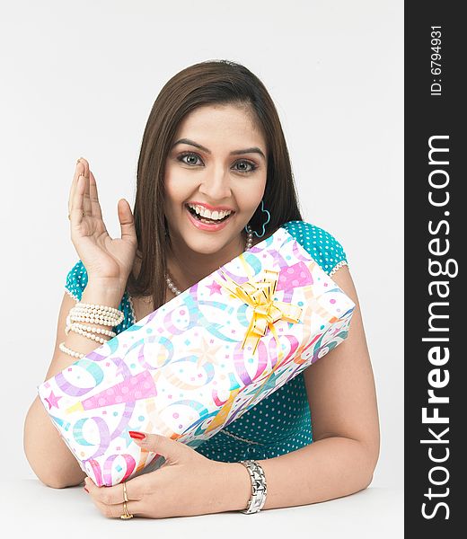 Asian woman of indian origin with a gift box. Asian woman of indian origin with a gift box