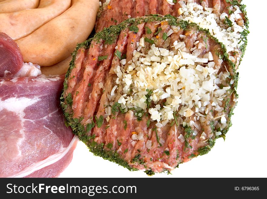 Variety of fresh meat garnished with lettuce and parsley, studio shot,