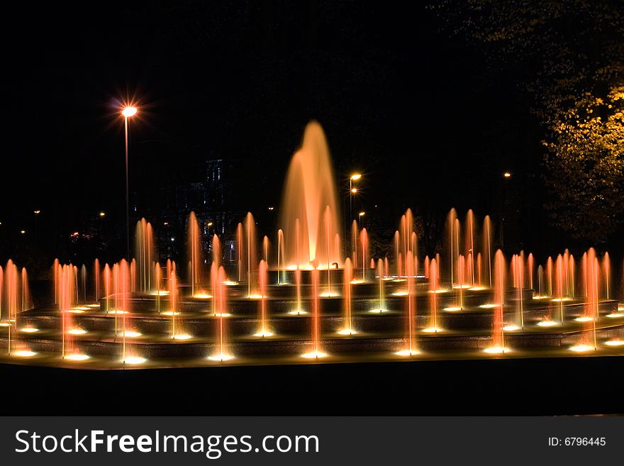 Illuminated fountain at dark night