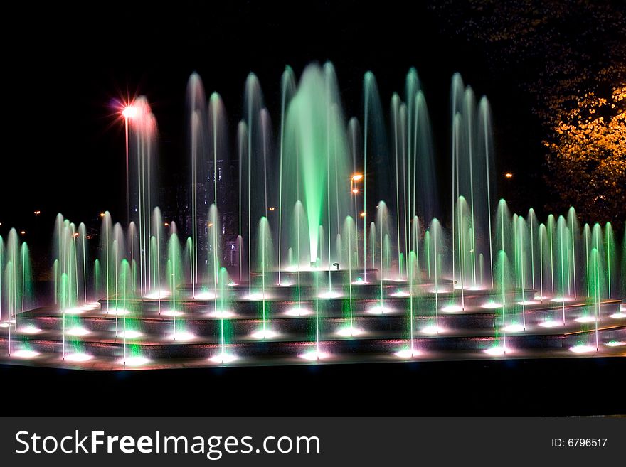 Illuminated fountain at dark night