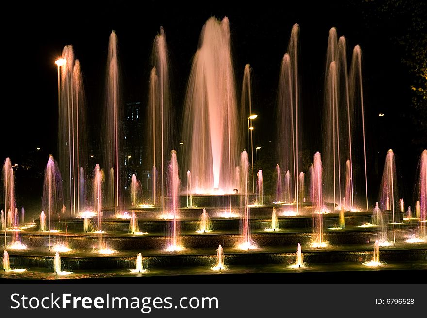 Illuminated fountain at dark night