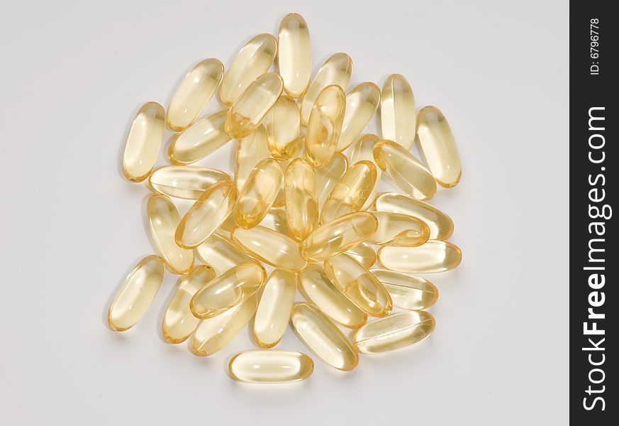 Vitamin Capsules randomly arranged on a white background