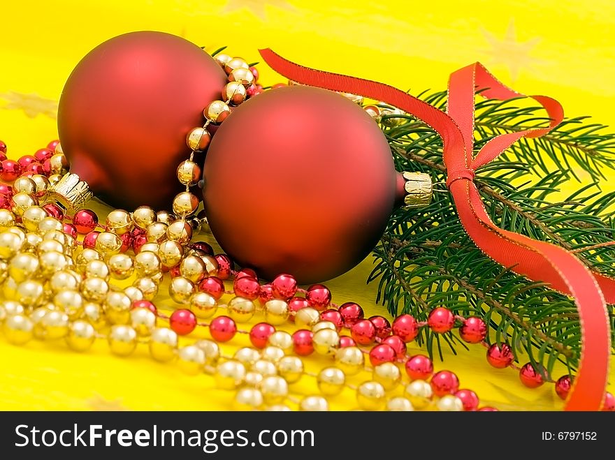 Two red balls with ribbon on the yellow background. Two red balls with ribbon on the yellow background