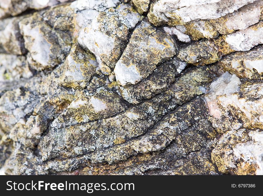 Abstract Rock texture with cracks and moss