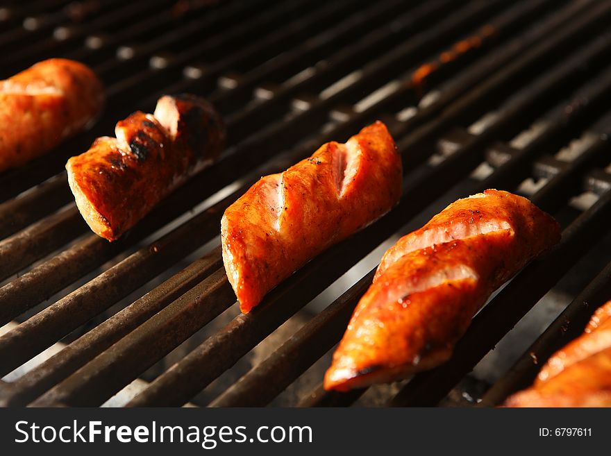 Juicy and fresh sausage over grill dark. Juicy and fresh sausage over grill dark