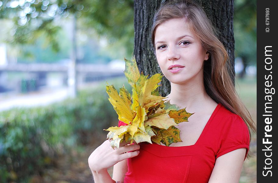 Woman with yellow  leaves