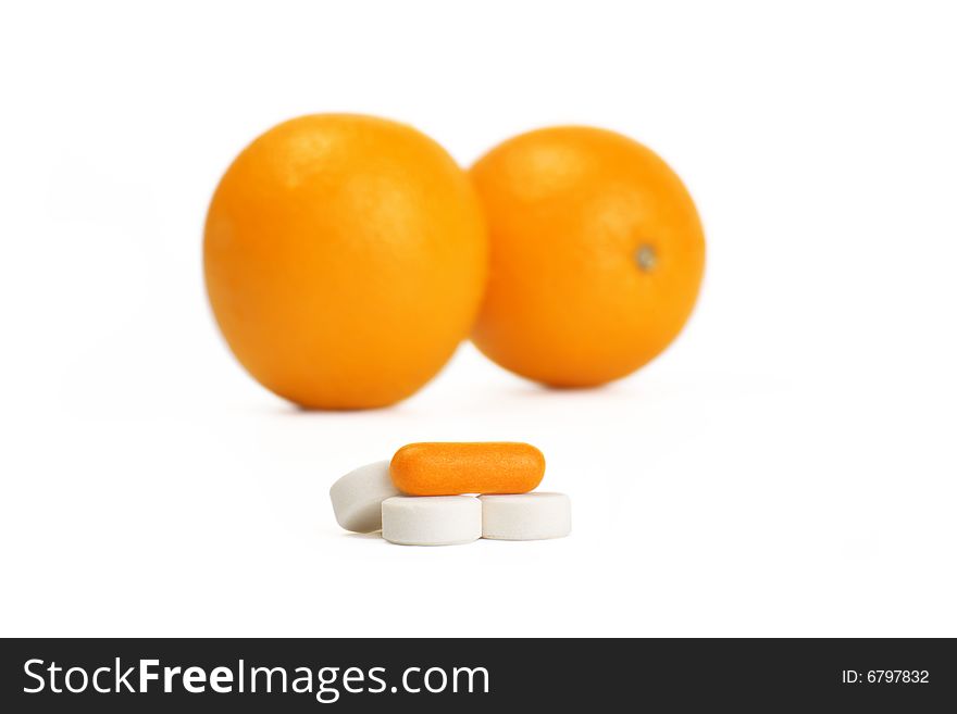 A photo of orange and pills. A photo of orange and pills